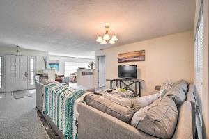 a living room with two couches and a flat screen tv at Waterfront Home with Dock, Kayaks, Pool and More! in Crystal River