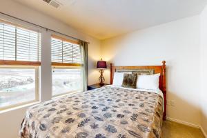 a bedroom with a bed and two windows at Fox Bay Escape in Heber City