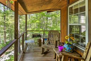 a porch with two rocking chairs and a grill at Lakefront Mountain Rest Cottage with Gas Fireplace! in Walhalla