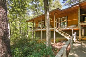 a house in the woods with a wrap around deck at Lakefront Mountain Rest Cottage with Gas Fireplace! in Walhalla