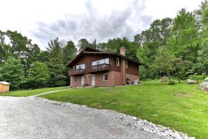 a large brick house on a grassy field at Breakaway House by Killington Vacation Rentals in Killington +1 photo