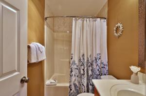 a bathroom with a shower curtain and a sink at The Pico Escape- 3BR 2BA Ski On Ski Off at Pico Mountain, Close to Killington, condo in Killington +21 photos