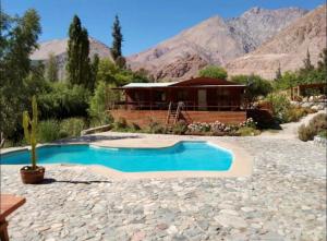 a home with a swimming pool and a house at OASIS DEL VALLE DEL ELQUI in La Serena