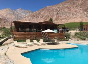 a resort with a pool and chairs and a house at OASIS DEL VALLE DEL ELQUI in La Serena
