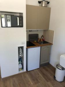 uma pequena cozinha com um lavatório e um micro-ondas em Studio +parking Bandol 3min à pied plage du vallat em Bandol