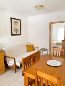 a living room with a couch and a table at T1 Perto da Praia Nazaré -The PI House in Nazaré
