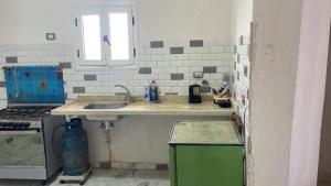 a kitchen with a sink and a stove at فيلا محمد بدر in Alexandria