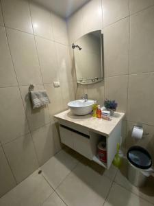 a white bathroom with a sink and a mirror at Bellini luxury - Puerto Santa Ana in Guayaquil