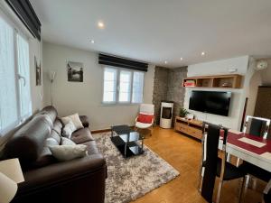 a living room with a couch and a flat screen tv at Zayas enea in Elizondo