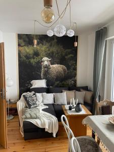 a living room with a couch and a painting of a sheep at Na stoku in Korbielów +53 photos
