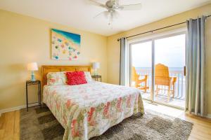 a bedroom with a bed and a window with a view of the ocean at Ocean Dunes 0903 in Kure Beach