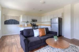 a living room with a couch and a table at Perfect 1BR In Prime Location & View of Stadiums in Detroit