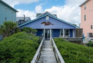 a blue house with a bird painted on it at Oceanfront Carolina Beach House - Dogs Allowed -Near Boardwalk in Carolina Beach