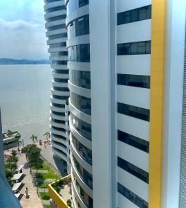 a view of a tall building next to a beach at Bellini luxury - Puerto Santa Ana in Guayaquil