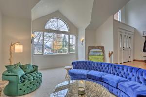 a living room with a blue couch and a chair at Redding Getaway with Hot Tub and Outdoor Kitchen! in Redding