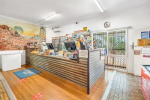 a coffee shop with a counter in a room at Outback Caravan Park Tennant Creek in Tennant Creek