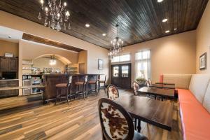 a living room with a couch and a bar at Best Western Bandera Suites & Saloon in Bandera
