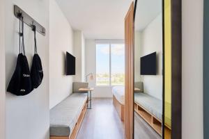 a bedroom with two beds and a window at Arlo Wynwood Miami in Miami