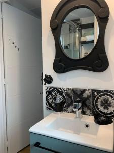 a bathroom with a sink and a mirror on the wall at Studio indépendant avec mezzanine in Provins