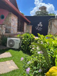 a television sitting in the grass in front of a house at Hostel LARes in Brumadinho