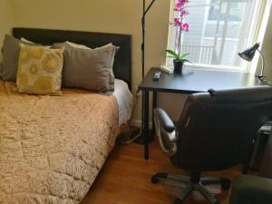 a bedroom with a desk and a bed and a chair at Most Economical Room in Center Washington DC in Washington, D.C.