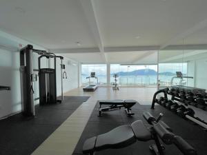 a gym with cardio equipment and a view of the ocean at The Cube Langkawi in Kuah