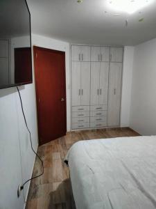 1 dormitorio con 1 cama y TV de pantalla plana en Casa Hermosa, en Nobsa