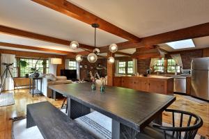 a kitchen with a large wooden table in a room at Forest Mountain Escape- Beautiful Mountaintop Escape in Mendon, VT, 20 min to Killington 14 to Pico, home in Mendon