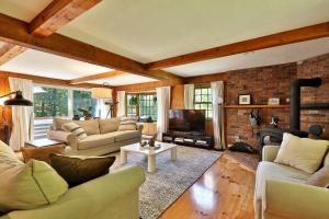a living room with couches and a fireplace at Forest Mountain Escape- Beautiful Mountaintop Escape in Mendon, VT, 20 min to Killington 14 to Pico, home in Mendon