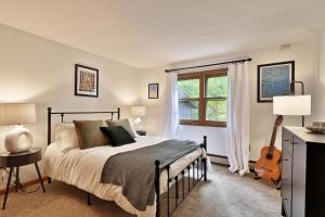 a bedroom with a bed and a guitar in it at Forest Mountain Escape- Beautiful Mountaintop Escape in Mendon, VT, 20 min to Killington 14 to Pico, home in Mendon