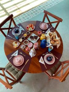 a table with breakfast foods on top of it at Amoreira Pousada em Barra Grande Piaui in Barra Grande