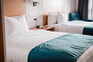 Postel nebo postele na pokoji v ubytování La Place Rendez-Vous Hotel