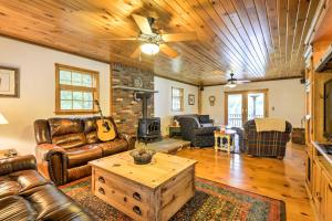 a living room with leather furniture and a wooden ceiling at Thompson Home with Deck and Pond, 8 Mi to Elk Mountain in Thompson