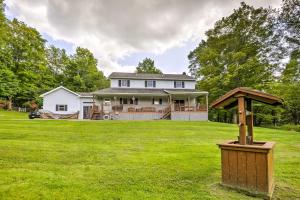 a house with a large yard with a wooden post at Thompson Home with Deck and Pond, 8 Mi to Elk Mountain in Thompson