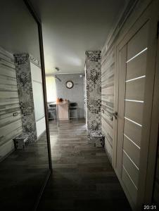 a hallway with a door and a table in a room at Ахметова 12 in Almaty