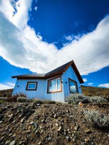 a blue house on top of a hill at Apart Azul Calafate in El Calafate