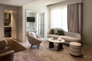 a living room with a couch and a table at The Playford Adelaide - MGallery in Adelaide