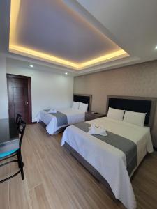 Postel nebo postele na pokoji v ubytování Hotel Cayuga