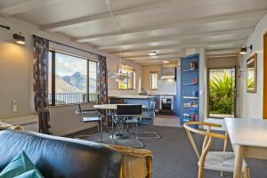 a living room with a couch and a table at Whakatipu Heights in Queenstown