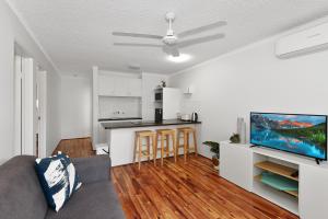 a living room with a couch and a kitchen at Allamanda Unit 22 in Long Jetty
