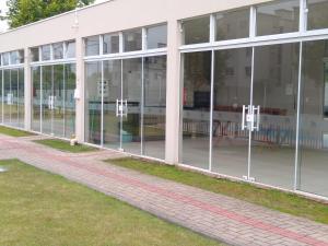 an empty building with glass windows on the side at Condomínio Ilha do Sol in Florianópolis