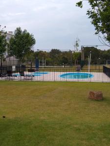 a park with two swimming pools in the background at Condomínio Ilha do Sol in Florianópolis