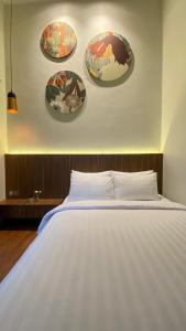 1 dormitorio con 1 cama con placas en la pared en Nadika Homes Private Pool, en Karangploso