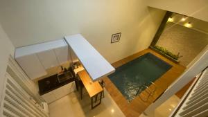 an overhead view of a kitchen and a swimming pool at Nadika Homes Private Pool in Karangploso
