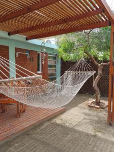 a hammock on the deck of a house at Antü in Puerto Pirámides