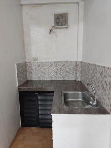 a kitchen with a sink and a counter top at Keneth Hostel 
