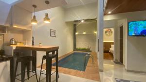 a kitchen and living room with a swimming pool at Nadika Homes Private Pool in Karangploso