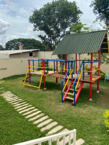 a playground with colorful equipment in a yard at Condomínio Recanto dos Dourados - Kitnet in Três Marias