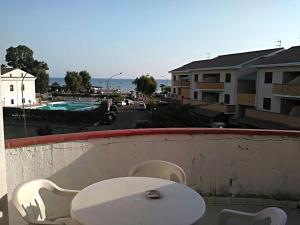 un tavolo e sedie su un balcone con vista sulla città di Lovely holiday home in Marina di Mandatoriccio with terrace a Mandatoriccio Marina