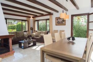 a dining room with a table and a fireplace at Villa Dos Pinos in Cala d´Or